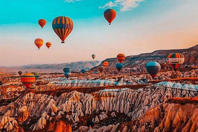 Balloon Watching Tour in Cappadocia with Hotel Pick-Up & Drop-Off - Red Valley sunrise views: dramatic rocks as balloons fill the sky